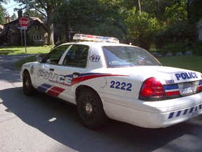 A Toronto Police cruiser was parked in the Etobicoke neighbourhood where a woman woke up to find an intruder inside her home on July 11, 2014. (Chris Doucette/Toronto Sun)