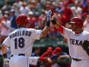 Mitch Moreland celebrates a homerun with Geovany Soto of the Texas Rangers against the Minnesota Twins at Rangers Ballpark in Arlington on September 1, 2013 in Arlington, Texas. (Ronald Martinez/Getty Images/AFP)