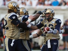 Winnipeg Blue Bombers Robert Marve (R) celebrates his touchdown in Montreal on Friday night. (CHRISTINNE MUSCHI/Reuters)