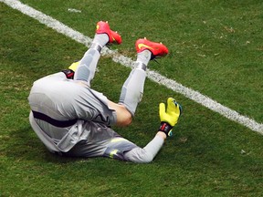 Brazil's goalkeeper Julio Cesar rolls on the pitch after conceding a goal to the Netherlands during their World Cup third-place game in Brasilia, July 12, 2014. (RUBEN SPRICH/Reuters)