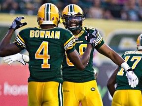 Adarius Bowman celebrates his three-touchdown night with teammate Akeem Foster on Friday (Codie McLachlan, Edmonton Sun).