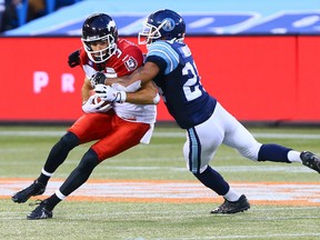 Antwaun Molden of the Toronto Argos takes down Brad Sinopoli of the Calgary Stampeders during CFL action on July 12. (Dave Abel, Toronto Sun)