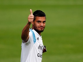 Argentina's goalkeeper Sergio Romero gives a thumbs-up as he arrives for a training session ahead of their 2014 World Cup final match against Germany in Vespasiano, July 10, 2014. (REUTERS/Marcos Brindicci)