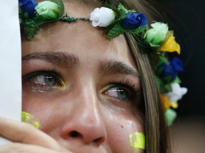 A fan of Brazil cries after they lost to the Netherlands in their 2014 World Cup third-place playoff at the Brasilia national stadium in Brasilia July 12, 2014. (REUTERS/Ueslei Marcelino)