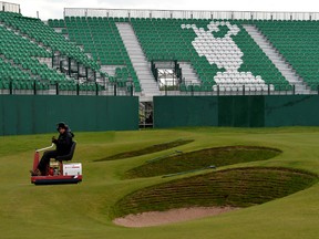 A groundsman works on the 18th green at the Royal Liverpool Golf Course in Hoylake. The British Open kicks off on Thursday. (AFP)