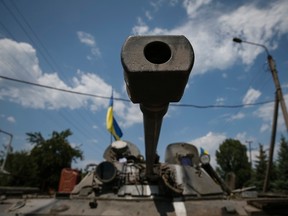 Ukrainian troops are pictured in the eastern Ukrainian town of Seversk July 12, 2014. Ukrainian war planes bombarded separatists along a broad front on Saturday, inflicting huge losses, Kiev said, after President Petro Poroshenko said "scores and hundreds" would be made to pay for a deadly missile attack on Ukrainian forces.  REUTERS/Gleb Garanich