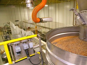 Huge dumpers of La Grille Montreal Steak Spice are then metered and fed into little bottles of the fast selling steak spice on a line at the London spice production facility in London, Ont. on Friday July 11, 2014. 
Mike Hensen/The London Free Press/QMI Agency