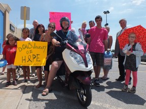 Don Wells sits atop his e-bike, surrounded by friends and supporters as his 15 day tour of Ontario comes neared its end on Saturday. The Port Lambton man had been riding across the province to raise money and awareness for cancer, a disease he is currently fighting. (BRENT BOLES, The Observer)