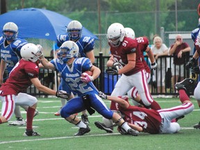 Sudbury Jr. Gladiators' Ian Christakos tries to break through Crimson Tide tackles during Ontario Football Conference play at James Jerome Sports Complex on Saturday.