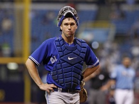 Blue Jays catcher Josh Thole waits for the results of a reviewed play at home plate that was later reversed, giving the Rays a run in the sixth inning in St. Petersburg on Sunday. (AFP/PHOTO)