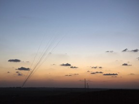 Smoke trails are seen as rockets are launched towards Israel from the northern Gaza Strip July 13, 2014.  REUTERS/Nir Elias