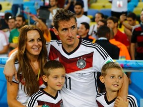 Germany's Miroslav Klose gathers with his wife Sylwia Klose and their twin sons, Noah Klose and Luan Klose, after the team won their World Cup final against Argentina at the Maracana stadium in Rio de Janeiro, Brazil on Sunday, July 13, 2014. (Kai Pfaffenbach/Reuters)
