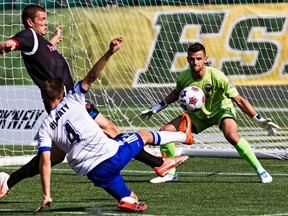 Edmonton's Neil Hlavaty can't get past Ottawa's goalkeeper Devala Gorrick during FC Edmonton's NASL soccer match against Ottawa Fury FC at Commonwealth Stadium in Edmonton, Alta., on Sunday, July 13, 2014. The match ended in a 0-0 draw. Codie McLachlan/Edmonton Sun/QMI Agency