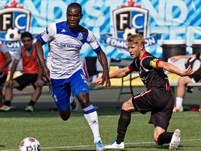 Edmonton's Lance Laing keeps the ball away from Ottawa's Ritchie Ryan during FC Edmonton's NASL soccer match against Ottawa Fury FC at Commonwealth Stadium in Edmonton, Alta., on Sunday, July 13, 2014. The match ended in a 0-0 draw. Codie McLachlan/Edmonton Sun/QMI Agency