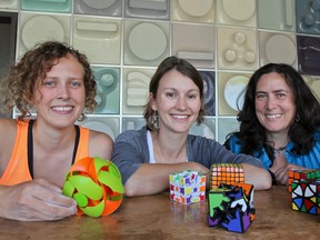 Math Quest instructors, from left, Suzanne Findleton, Carly Rozins and camp director Siobhain Broekhoven show some of the puzzles that are a part of the girls summer camp's fun-style learning. (Julia McKay/The Whig-Standard)