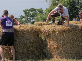 Participants climb over hay bales during the second annual Cannonball Rush at Fort Henry on Saturday. (Julia McKay/The Whig-Standard)