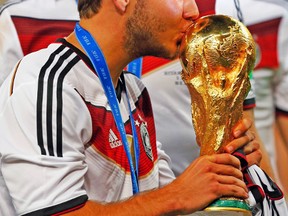Germany's Mario Gotze kisses the trophy after winning the World Cup on Sunday. (REUTERS)