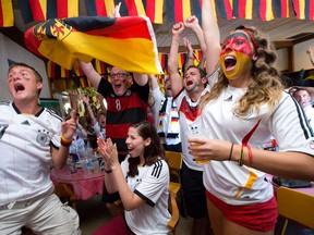 Fans watching the World Cup final at the German-Canadian Club ? Danny Breuninger, left, Alex Davidson, Shauna-Lynn Fink, Justin Hickson and Erika Kalus ? leap out of their seats after Germany scored on Sunday. (CRAIG GLOVER, The London Free Press)