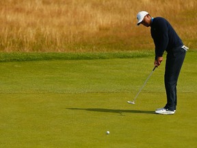 Tiger Woods putts on the 12th green during a practice round ahead of the British Open Championship at the Royal Liverpool Golf Club in Hoylake, England, on Sunday. (AFP)