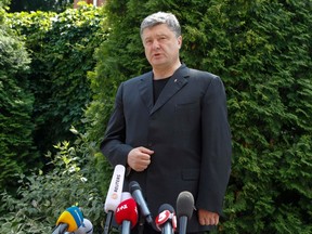 Ukraine's President Petro Poroshenko speaks to media after attending a memorial service of the Metropolitan of Kiev and all Ukraine Vladimir in Kiev July 5, 2014. REUTERS/Valentyn Ogirenko