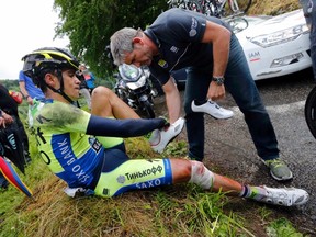 Tinkoff-Saxo team rider Alberto Contador of Spain gets medical assistance after he fell during the 161.5 km 10th stage of the Tour de France between Mulhouse and La Planche Des Belles Filles on Monday, July 14, 2014. (Jean-Paul Pelissier/Reuters)