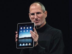 Steve Jobs holds up an iPad during its launch in San Francisco, in this Jan. 27, 2010 file photograph. REUTERS/Kimberly White/Files