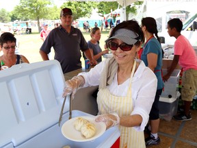 Doma Rhidar serves Tibetan momo dumplings and vegetable stir-fried noodles tent during the Belleville Waterfront and Ethnic Festival Saturday, Jul 12 2014 in Belleville, Ont. Lineups were common as visitors sampled the variety available. 
Luke Hendry/Belleville Intelligencer