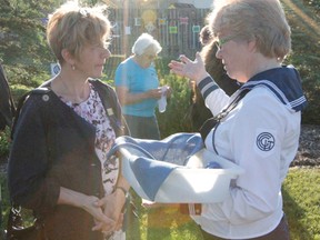 Local Canadian Girls in Training leader Dianne Nikiforuk speaks to Communities in Bloom judge Claire Laberge during a welcoming ceremony held at the peace pole in Northview Park  for the two judges on July 8.