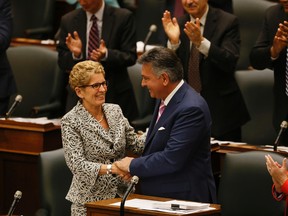 Premier Kathleen Wynne and Finance Minister Charles Sousa on budget day at Queen's Park. (STAN BEHAL, Toronto Sun)