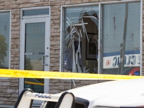 Edmonton Police Service officers investigate after a violent break-in in at HELM Property Management near 156 Street and Stony Plain Road in Edmonton, Alta., on Monday, July 14, 2014. Ian Kucerak/Edmonton Sun
