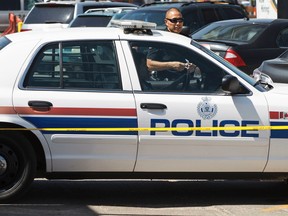 Edmonton Police Service officers investigate after a violent break-in in at HELM Property Management near 156 Street and Stony Plain Road in Edmonton, Alta. Ian Kucerak/Edmonton Sun/QMI Agency