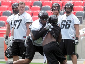 The Ottawa RedBlacks practice at TD Place at Lansdowne Park Monday July 14, 2014. RedBlack Jeraill McCuller works the line during practice Monday. The Ottawa Redblacks play their home opener in Ottawa Friday, July 18, 2014  
Tony Caldwell/Ottawa Sun/QMI Agency