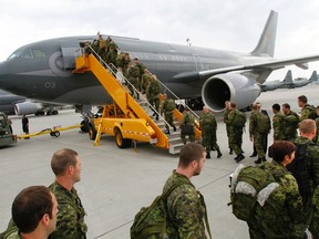 A Canadian Army contingent of about 120 members from 3rd Battalion, Royal Canadian Regiment, part of 2 Canadian Mechanized Brigade Group based in Garrison Petawawa, Ont., board a C-150 Airbus from 437 Transport Squadron at 8 Wing/CFB Trenton, Ont. prior to heading to Easter Europe Monday, July 14, 2014.- JEROME LESSARD/THE INTELLIGENCER/QMI AGENCY