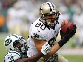 New Orleans Saints' Jimmy Graham scores a touchdown on a pass reception as New York Jets' Jaiquawn Jarrett tries to tackle him in the first quarter during their NFL football game in East Rutherford, New Jersey, November 3, 2013. (REUTERS/Gary Hershorn)