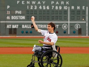 Boston Marathon survivor Jeff Bauman throws out a ceremonial first pitch before the MLB interleague baseball game between the Philadelphia Phillies and the Boston Red Sox at Fenway Park in Boston, Massachusetts May 28, 2013.  REUTERS/Brian Snyder