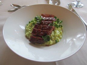 Duck breast on a bed of pea risotto.