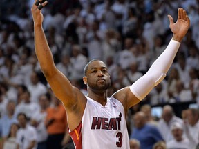 Miami Heat guard Dwyane Wade tries to get the crowd involved against the Indiana Pacers in game four of the Eastern Conference Finals at American Airlines Arena on May 26, 2014. (Steve Mitchell/USA TODAY Sports)