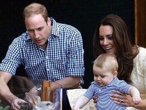 Britain's Catherine, Duchess of Cambridge, holds her son George, next to her husband Prince William (L) as they meet a bilby named George after the young prince, at Taronga Zoo in Sydney April 20, 2014.  REUTERS/Chris Jackson
