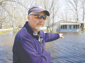 Don Clarkson, chairman of the Delta Beach Association and a resident of Delta Beach, shows 2011 fooding. (ANGELA BROWN/QMI Agency files)