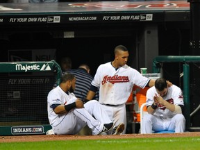 Cleveland Indians designated hitter Carlos Santana (left), left fielder Michael Brantley (center) and second baseman Jason Kipnis react after losing to the Tampa Bay Rays in the American League wild card playoff game at Progressive Field on Oct 2, 2013 in Cleveland, OH, USA. (David Richard/USA TODAY Sports)