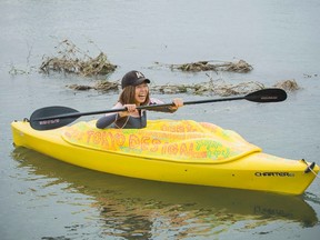 Japanese artist Megumi Igarashi, known as Rokudenashiko, paddles in her kayak modelled on her vagina in the Tama river in Tokyo in this October 19, 2013 picture provided by Eigo Shimojo. (REUTERS/Eigo Shimojo/Handout via Reuters)