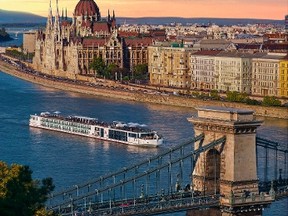 A Viking River Cruise is the perfect way to glide into Budapest. Pictured here the new Viking Rinda longship on the Danube River with Royal Palace in the background and Chain Bridge in the foreground. (Courtesy Viking River Cruise)