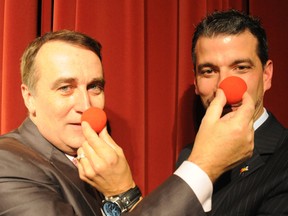 Belleville mayor Neil Ellis (left) and Quinte West's manager of human resources, Tim Osborne, place red noses on each other during the launch of Operation Red Nose at The Empire Theatre in Belleville. Ellis and Quinte West mayor John Williams, who could not attend Tuesday's launch, will serve as honourary co-chairmen of the annual festive program. 
W. BRICE MCVICAR/The Intelligencer