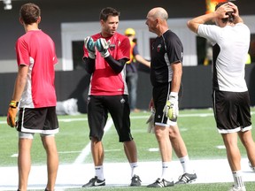 Ottawa Fury FC goalkeeper Romuald Peiser talks with guest coach Bruce Grobbelaar at TD Place on Wednesday, July 16, 2014. Grobbelaar, who played goal for Liverpool of the English Premier League for 14 years, will be with the Fury for at least two weeks. (Chris Hofley/Ottawa Sun/QMI Agency)