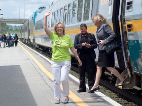 Federal Green Party leader Elizabeth May is greeted by supporters on the platform at the Via station in Kingston on Wednesday. May spent three minutes on the platform talking to supporters before getting back on the train. She's heading to Fredericton for the party's 2014 convention. CHLOE SOBEL/FOR THE WHIG-STANDARD