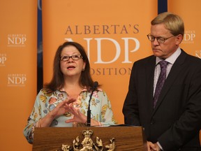 Lucia Lorio (L) with NDP'S David Eggen speaks to the media about the long waits for cancer patients at the Alberta Legislature in Edmonton, Alberta on July16, 2014.  The NDP is calling for a review of breast cancer care. Perry Mah/Edmonton Sun