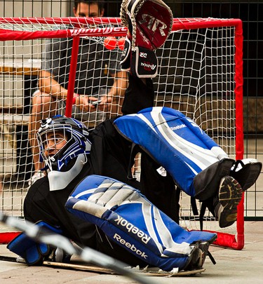 Goaltender Luis Torres is splayed out after making a save during the Five Hole for Food ball hockey tournament at Centennial Plaza in Edmonton, Alta., on Wednesday, July 16, 2014. The aim of the tournament is to gather donations for local food banks. Edmonton is the 11th stop out of 13 on this year's tour. Codie McLachlan/Edmonton Sun/QMI Agency