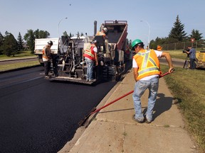 Summer road construction, like this repaving on 106 Avenue earlier this week, is a painful necessity in Edmonton, says Lorne Gunter. (Perry Mah/Edmonton Sun)