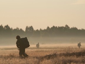 Following an airborne insertion, paratroopers from 3rd Battalion, Princess Patricia�s Canadian Light Infantry (3PPCLI) based in Edmonton,  march to their staging area to conduct an exercise in the Oleszno training area of Poland on July 4, 2014 as part of NATO reassurance exercises. Photo: Sgt Bern LeBlanc, Canadian Army Public Affairs