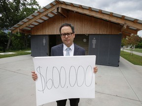Councillor Denzil Minnan-Wong stands out front the public washroom built at the Cherry Beach Sports Fields on Unwin Ave. on Wednesday July 16, 2014. Minnan-Wong is upset the Waterfront spent $ 600,000 in total on the project. (Craig Robertson/Toronto Sun)